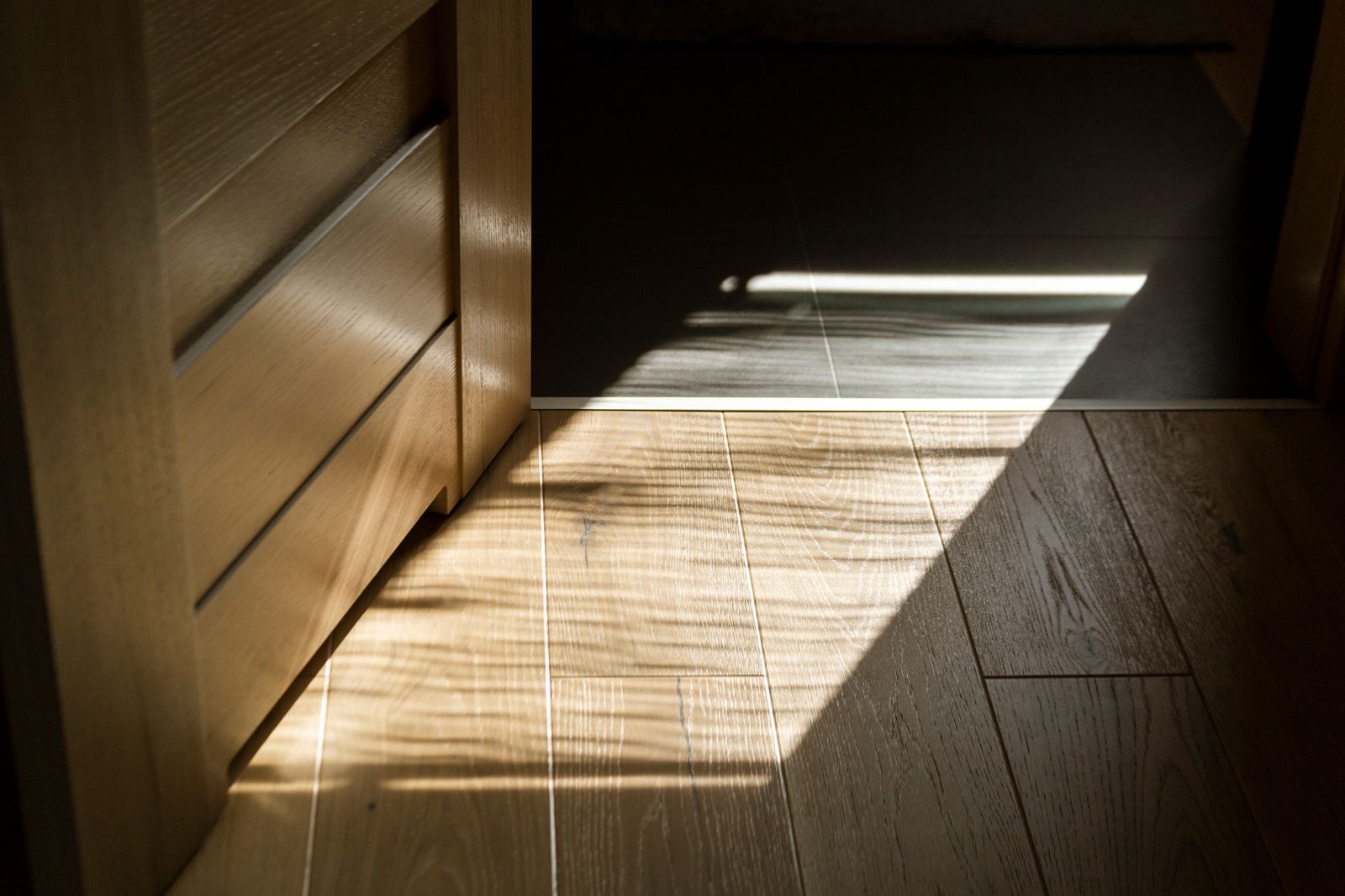 Sunlight across detailed wood flooring